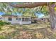Spacious backyard with mature trees and a screened-in porch at 129 Nw Lincoln N Cir, St Petersburg, FL 33702
