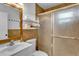 Bathroom featuring tile walls, a vanity with a mirror, and a shower with a sliding glass door at 129 Nw Lincoln N Cir, St Petersburg, FL 33702