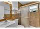 Bathroom featuring tile walls, a vanity with a mirror, and a shower with a sliding glass door at 129 Nw Lincoln N Cir, St Petersburg, FL 33702