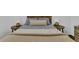 Bedroom with a comfortable bed, side tables with lamps, and a dresser for storage at 129 Nw Lincoln N Cir, St Petersburg, FL 33702
