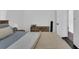 Cozy bedroom featuring neutral tones, dresser, and plush bedding at 129 Nw Lincoln N Cir, St Petersburg, FL 33702