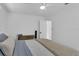 Bright bedroom with a ceiling fan, dresser, closet, and comfortable bed with a cozy blanket at 129 Nw Lincoln N Cir, St Petersburg, FL 33702