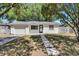 Charming home with a well-manicured front yard, stepping stone walkway, and a convenient attached garage at 129 Nw Lincoln N Cir, St Petersburg, FL 33702