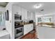 Bright kitchen features white cabinets, stainless steel appliances, and granite countertops at 129 Nw Lincoln N Cir, St Petersburg, FL 33702