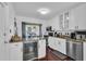 Bright kitchen features white cabinets, stainless appliances, and a wine fridge, perfect for entertaining at 129 Nw Lincoln N Cir, St Petersburg, FL 33702