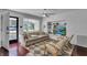 Cozy living room featuring a neutral sofa, modern ceiling fan, and a built-in entertainment center at 129 Nw Lincoln N Cir, St Petersburg, FL 33702
