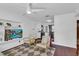 Bright living room with sleek hardwood floors, a ceiling fan, and built in shelving for a modern feel at 129 Nw Lincoln N Cir, St Petersburg, FL 33702