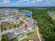 Drone image of neighborhood near lakes and green space with house marked by red icon at 13042 Pennybrook Dr, Riverview, FL 33579