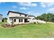 An expansive backyard with well-maintained lawn and a paver patio offers a relaxing outdoor space at 13042 Pennybrook Dr, Riverview, FL 33579