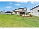 An expansive backyard offers a covered patio, manicured lawn, and serene landscaping at 13042 Pennybrook Dr, Riverview, FL 33579