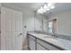 Bathroom featuring double sinks with granite countertops and a large mirror at 13042 Pennybrook Dr, Riverview, FL 33579