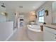 Bright bathroom featuring a large tub, granite counter tops, walk-in shower and tile flooring at 13042 Pennybrook Dr, Riverview, FL 33579