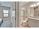 Well-lit bathroom features a shower with glass door, modern vanity, and neutral decor at 13042 Pennybrook Dr, Riverview, FL 33579