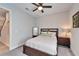 Cozy bedroom featuring neutral decor with a large mirror, ceiling fan, and carpeted floors at 13042 Pennybrook Dr, Riverview, FL 33579