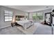 Serene bedroom with bright windows and a stylish accent mirror at 13042 Pennybrook Dr, Riverview, FL 33579