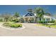 The exterior view of the community clubhouse showcases its inviting architecture and landscaping at 13042 Pennybrook Dr, Riverview, FL 33579
