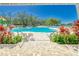 Resort-style community pool with tropical landscaping, lounge chairs, and shaded seating areas at 13042 Pennybrook Dr, Riverview, FL 33579