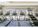 Bright gym with treadmills and stair climbers in front of a large window at 13042 Pennybrook Dr, Riverview, FL 33579