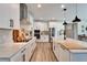 Modern kitchen featuring stainless steel appliances, a large island with sink, and white cabinetry at 13042 Pennybrook Dr, Riverview, FL 33579