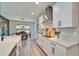 Well-lit kitchen featuring stainless steel appliances, white cabinets, and an open layout to the dining area at 13042 Pennybrook Dr, Riverview, FL 33579