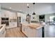 Bright kitchen with stainless steel appliances, farmhouse sink, and an open view to the living room at 13042 Pennybrook Dr, Riverview, FL 33579