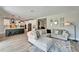 Bright living room boasts an open layout with a large sectional sofa and kitchen access at 13042 Pennybrook Dr, Riverview, FL 33579