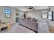 Spacious room with modern sofa, multiple windows, and stylish ceiling fan at 13042 Pennybrook Dr, Riverview, FL 33579