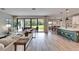 Open-concept living space with modern furniture, sliding doors to patio, and dining area at 13042 Pennybrook Dr, Riverview, FL 33579