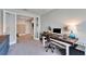 Bright home office featuring wood desk, glass doors and open view to the living space at 13042 Pennybrook Dr, Riverview, FL 33579
