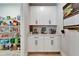 Butler's pantry boasts white cabinetry and countertop space, alongside an open walk-in pantry with wire shelving at 13042 Pennybrook Dr, Riverview, FL 33579