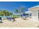 Community pool area features stylish seating with comfortable couches and a blue and white clubhouse at 13042 Pennybrook Dr, Riverview, FL 33579
