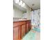 Bathroom showcasing a spacious vanity with granite countertop and decorative shower curtain for added style at 13923 Arbor Pines Dr, Riverview, FL 33579