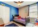 Cozy bedroom with ceiling fan, blue accent wall, and a playful Spider-Personal theme at 13923 Arbor Pines Dr, Riverview, FL 33579