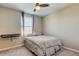 Simple bedroom with a ceiling fan, neutral walls, and a cozy bed at 13923 Arbor Pines Dr, Riverview, FL 33579