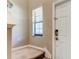 Inviting entryway with a white door, neutral walls, and carpeted stairs at 13923 Arbor Pines Dr, Riverview, FL 33579