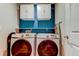 Efficient laundry room with Samsung washer and dryer and white wall-mounted cabinets at 13923 Arbor Pines Dr, Riverview, FL 33579