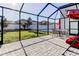 Enclosed patio featuring pavers, seating, and a view of the fenced backyard at 13923 Arbor Pines Dr, Riverview, FL 33579