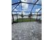 Enclosed patio featuring brick pavers, dining table and chairs, and a view of the fenced backyard at 13923 Arbor Pines Dr, Riverview, FL 33579