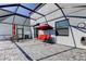 Enclosed patio featuring pavers, seating, and an outdoor dining set with an umbrella at 13923 Arbor Pines Dr, Riverview, FL 33579