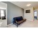 Cozy upstairs sitting area with futon, overhead lighting, and neutral paint at 13923 Arbor Pines Dr, Riverview, FL 33579