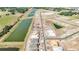 Aerial view of homes under construction and ponds, showcasing serene and developing community with harmonious natural elements at 15238 Rainbow Quartz St, Wimauma, FL 33598