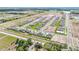 Expansive aerial view of a neighborhood with well-maintained homes and manicured lawns, offering a serene and Gathering-friendly environment at 15238 Rainbow Quartz St, Wimauma, FL 33598