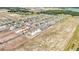 Aerial view of homes under construction, set in a community surrounded by natural landscapes, offering future tranquil living at 15238 Rainbow Quartz St, Wimauma, FL 33598