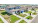 A two-story blue home sits on a landscaped lot in a residential community at 15238 Rainbow Quartz St, Wimauma, FL 33598
