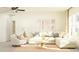 Bright living room featuring a cozy sectional sofa, ceiling fan, and neutral decor at 15238 Rainbow Quartz St, Wimauma, FL 33598