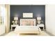 Cozy bedroom with a king bed, bedside tables, decorative lamps, and a soft rug at 15238 Rainbow Quartz St, Wimauma, FL 33598