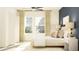 Bright and airy bedroom featuring a bed with decorative pillows, neutral color palette, and two windows at 15238 Rainbow Quartz St, Wimauma, FL 33598