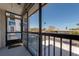 Screened balcony overlooking a neighborhood street with palm trees and clear blue skies at 171 Medallion Blvd # F, Madeira Beach, FL 33708