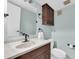 Bathroom features a single sink vanity, wood cabinet, vanity mirror, and toilet at 171 Medallion Blvd # F, Madeira Beach, FL 33708