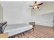 Bright bedroom featuring wood floors, a ceiling fan, and a high vaulted ceiling at 171 Medallion Blvd # F, Madeira Beach, FL 33708